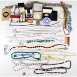 A collection of costume jewellery including beads, Art Deco French pin, garnet necklace, enamel