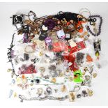 A collection of costume jewellery including earrings, brooches, necklaces, etc