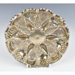 Victorian hallmarked silver pierced and embossed bon bon dish raised on three ball feet,
