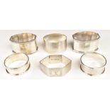 Six various hallmarked silver napkin rings including a near pair of faceted examples, weight of