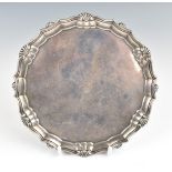 Victorian hallmarked silver card tray or small salver with shaped edge, raised on three feet. London