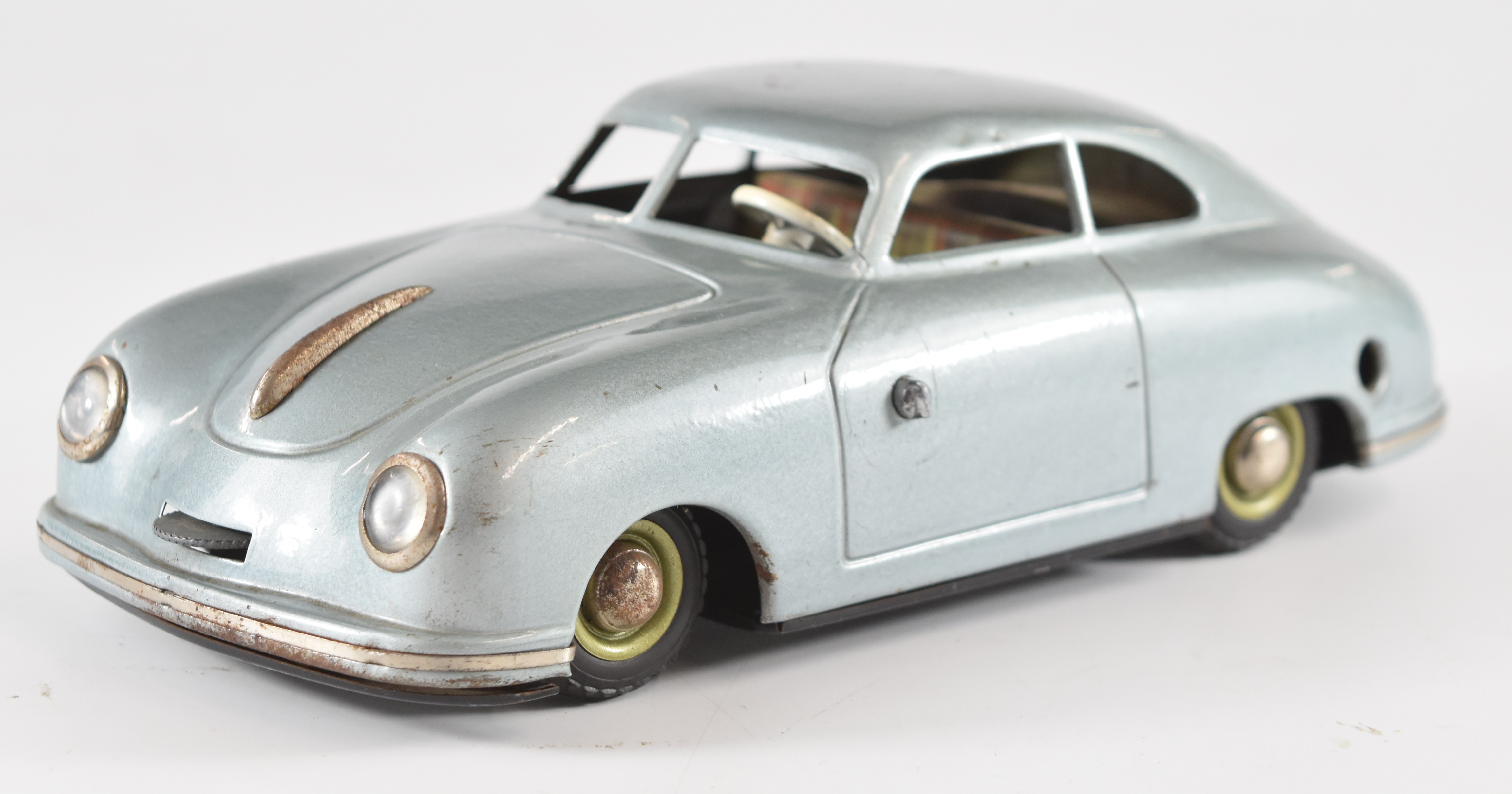 JNF Prototyp Porsche 356 tinplate clockwork car with metallic blue body and plaid interior.