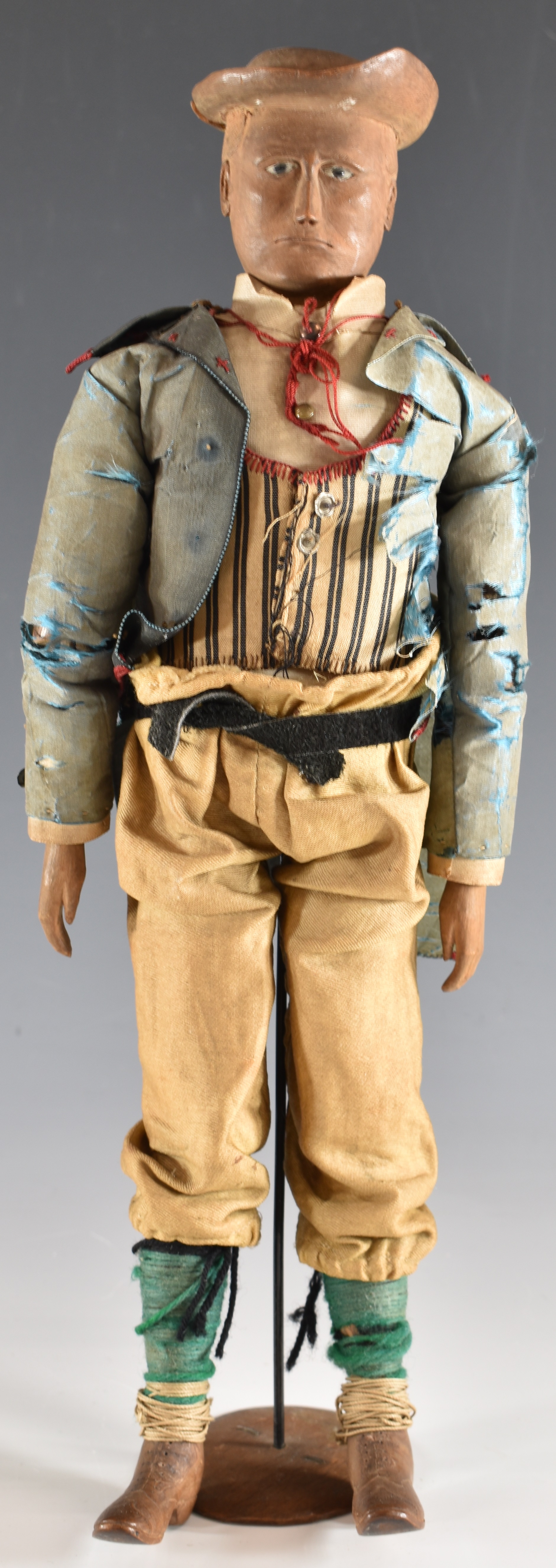 19thC carved wooden doll/ lay figure with articulated limbs, silk jacket and wooden boots,