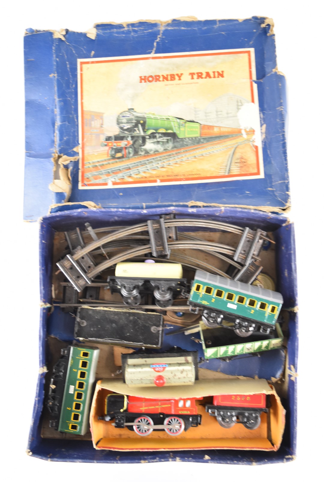 Hornby 0 gauge model railway set comprising clockwork tender locomotive and six various wagons.