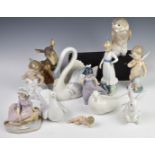 A collection of Lladro / Nao figures including Cupid, deer and fawn etc, tallest 21cm