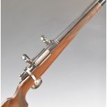 Unnamed .243 bolt-action rifle with chequered semi-pistol grip and forend, raised cheek-piece, sling