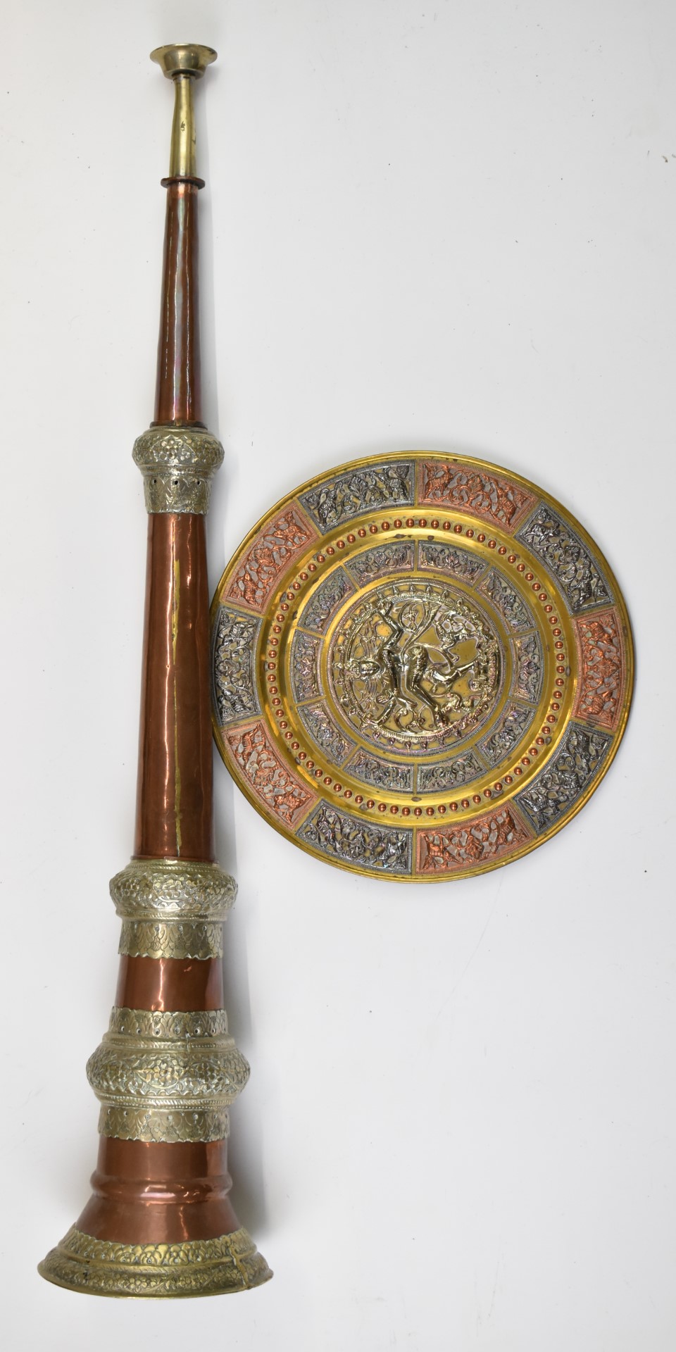 Tibetan copper horn, white metal and copper on brass charger with deity decoration and a pair of