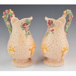 Clarice Cliff pair of pink Celtic Harvest pedestal jugs, height 20cm