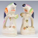 A pair of Staffordshire figural parrot pen or spill holders, height 13.5cm