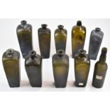 Ten late 18th / early 19thC glass gin and wine bottles some with original iridescent finish and