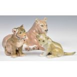 Copenhagen figure of a recumbent lioness and two cubs, tallest 16cm