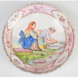 A 19thC porcelain test dish decorated with washerwomen and a complete test palette of colours verso,