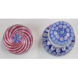 Two John Deacons glass paperweights, one in the form of a inkwell with signature thistle cane to the