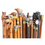 Approximately twenty walking sticks / canes in an oak umbrella or stick stand, the sticks include