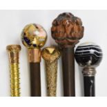Five walking sticks / canes including a porcelain Queen Victoria portrait example dated 1837, banded