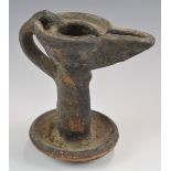 Terracotta pottery oil lamp of some antiquity with traces of original glaze, possibly slipware,