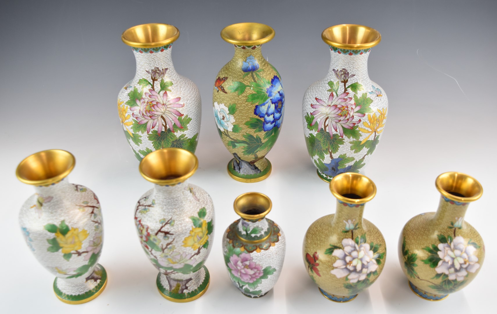 Eight Chinese cloisonné vases including three pairs, tallest 22cm