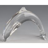 Baccarat glass leaping dolphin paperweight with etched logo to tail, 12cm long.