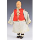 Chinese 'Door of Hope' child doll wearing a pale blue silk robe, red jacket and pink under trousers,