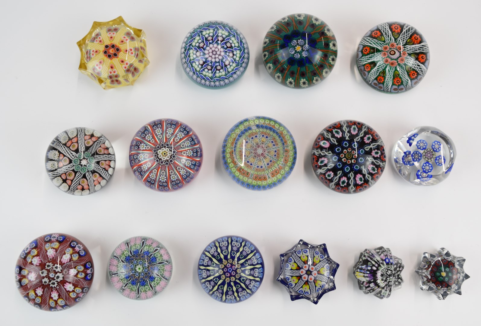 Fifteen Perthshire, Strathearn and similar millefiori glass paperweights including faceted and