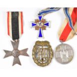 Three German Third Reich Nazi medals comprising Mother's Cross, Social Welfare Medal and War Merit