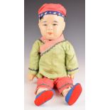 Chinese 19th / 20thC doll wearing a green silk jacket, height 40cm