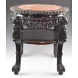 Chinese 19thC padauk wood table with carved and pierced decoration figural legs, ball and claw