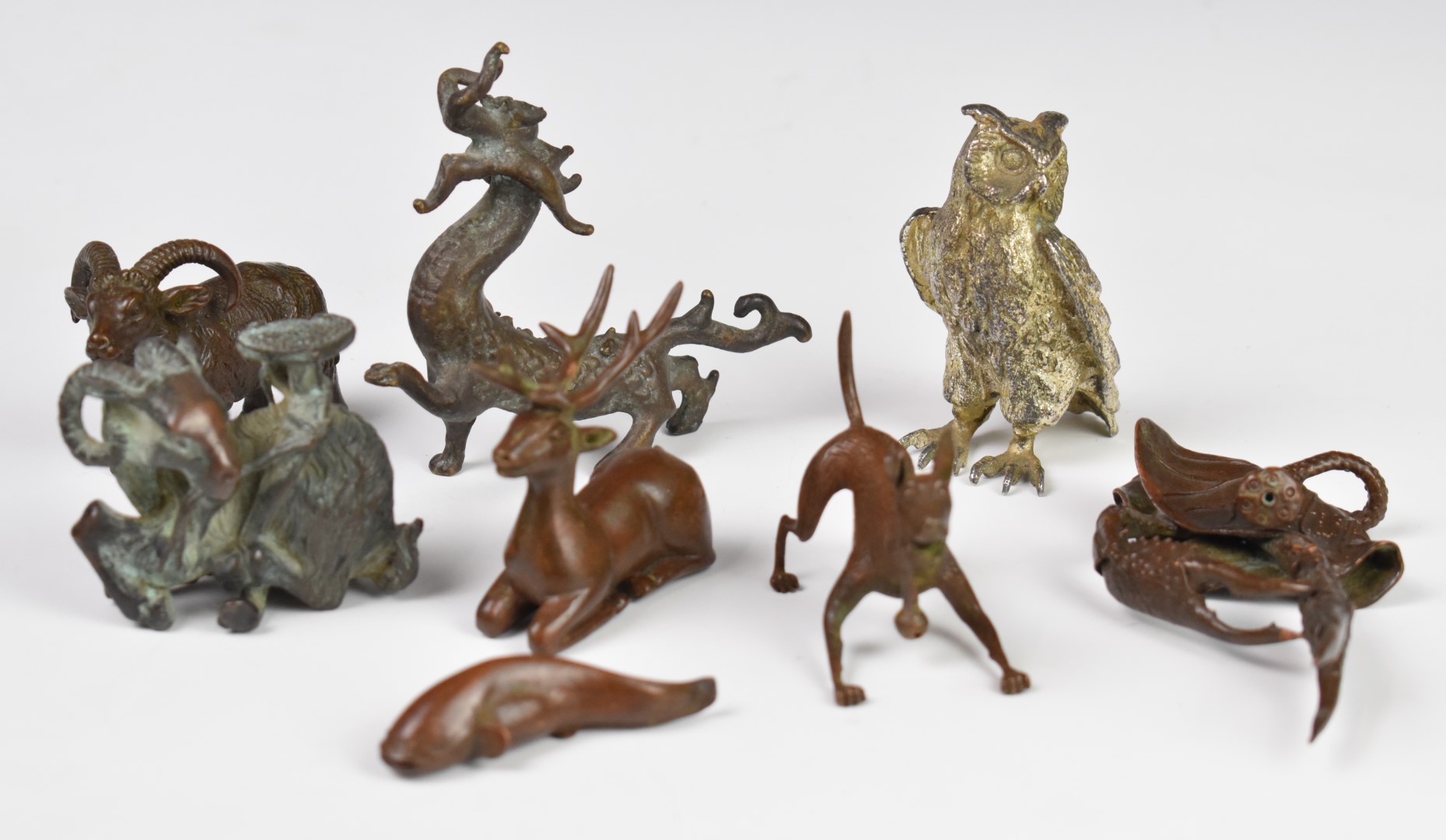 Collection of Japanese and Chinese bronze and cast metal animals including dragon, goat etc