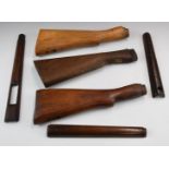 Three wooden Enfield or similar military style rifle stocks and furniture.