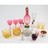 Fifteen pieces of clear and coloured decorative glassware including cranberry decanter with floral