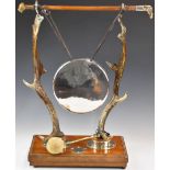 Victorian novelty taxidermy interest gong, the stand formed by two antlers and a riding or hunting