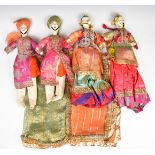 Four early 20thC Indian dolls wearing traditional costumes and high grade miniature gold