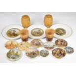 A collection of Prattware pot lids and plates including shooting bears, Winchcombe pottery beakers