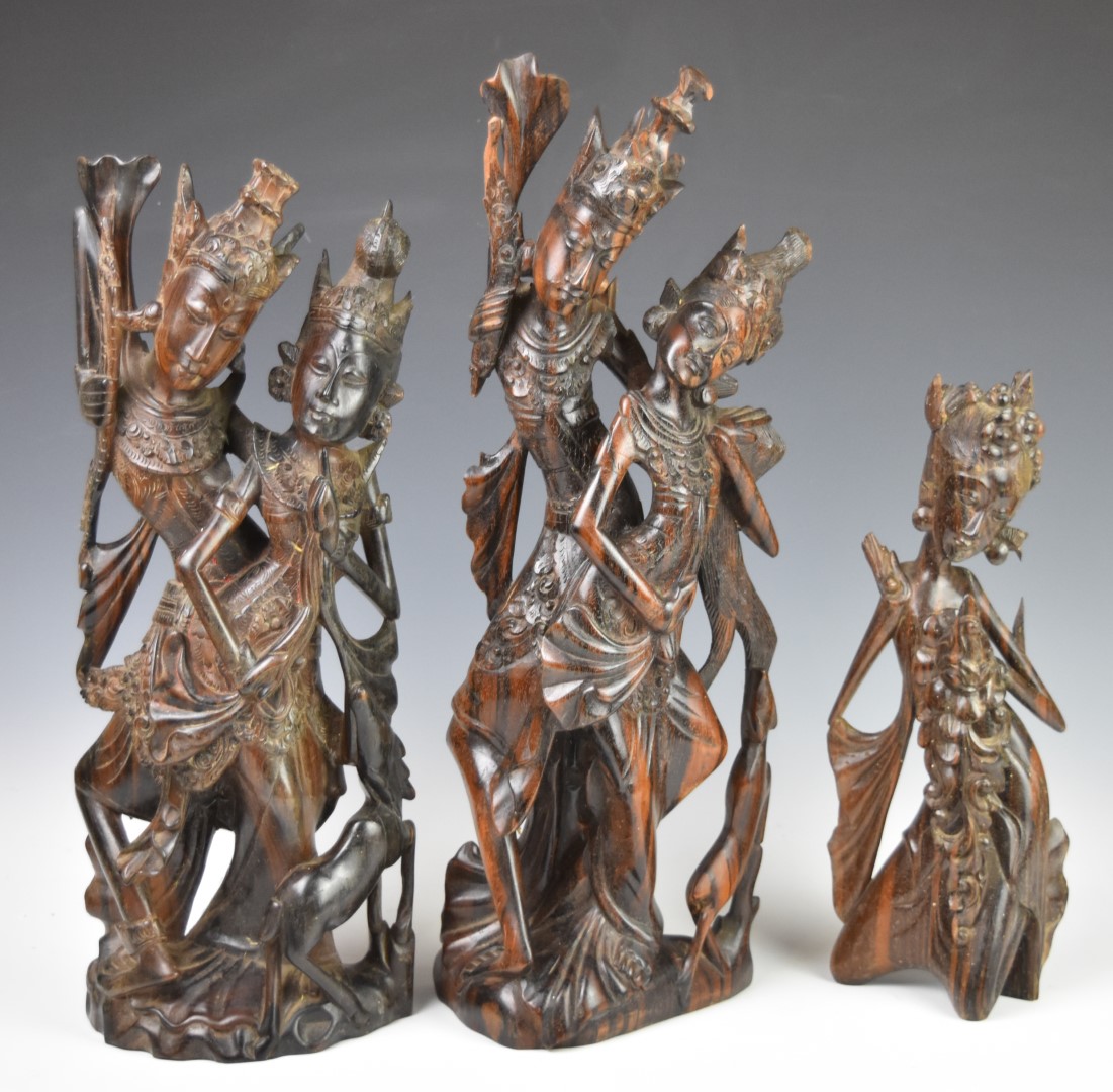 Three Indonesian or similar carved wooden figures, height of tallest 50cm