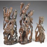 Three Indonesian or similar carved wooden figures, height of tallest 50cm