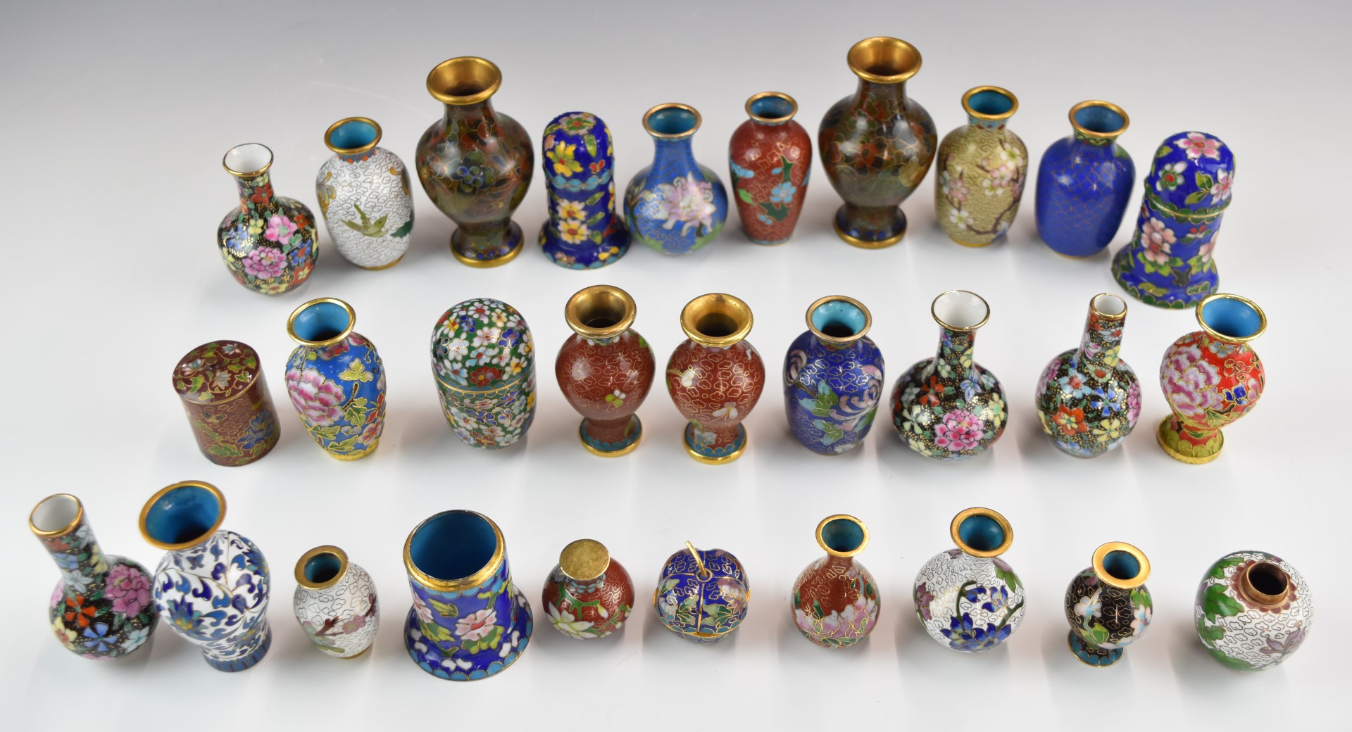 A collection of Chinese cloisonné miniature vases including some pairs, tallest 10cm