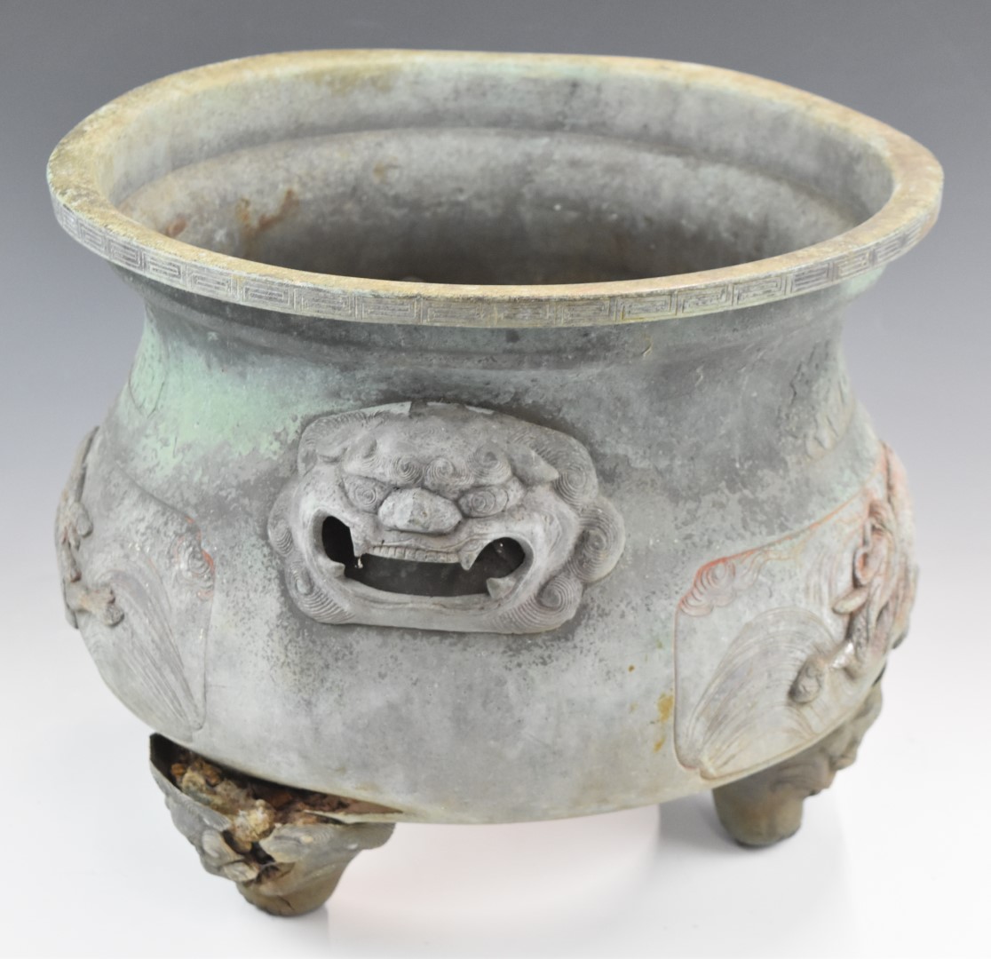 Chinese bronze jardiniere, possibly Ming, with relief moulded dragon and script decoration, raised