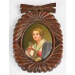19th / 20thC porcelain oval plaque decorated with a girl holding a flower, in carved wooden frame, 8