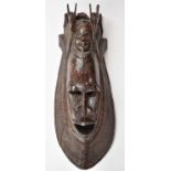 Large African tribal mask with adzed decoration and antelope finials, height 77cm