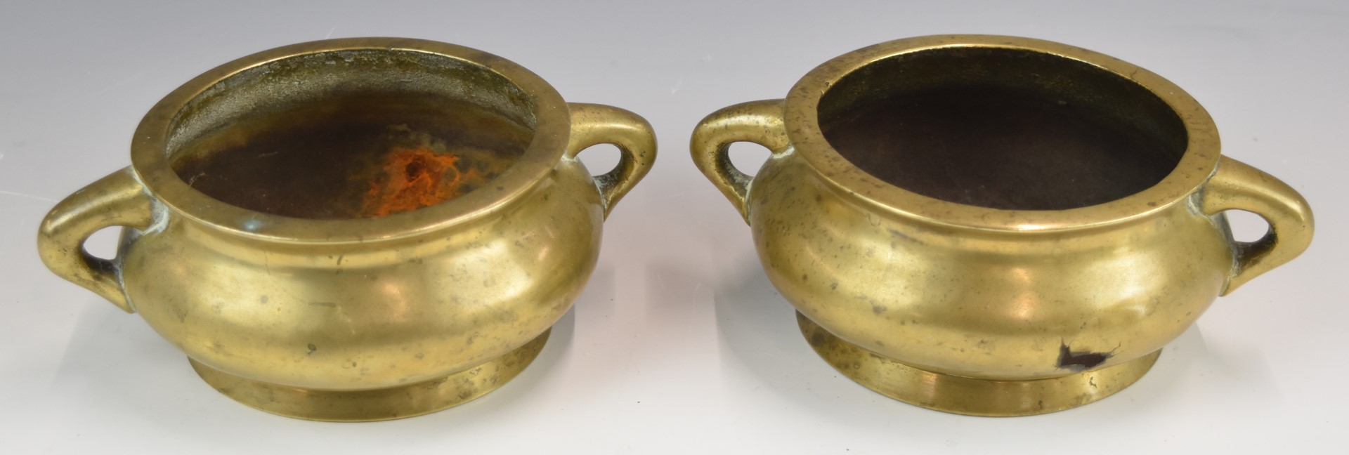 A pair of Chinese 19th / 20thC twin handled pedestal bronze censers with six character marks to