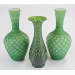Three Stourbridge glass vases comprising a pair of quilted air trap satin bottles vases (21.5cm