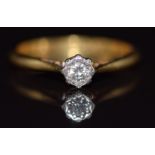 An 18ct gold ring set with a diamond in a platinum setting, 2g, size J
