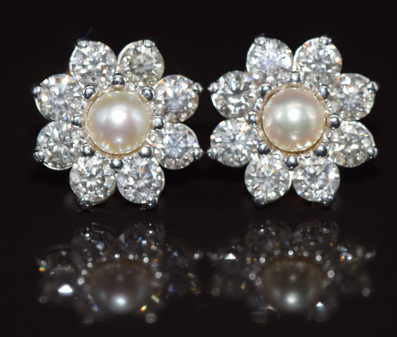 A pair of 18ct white gold earrings each set with a natural pearl measuring 5.3mm surrounded by eight - Image 2 of 3