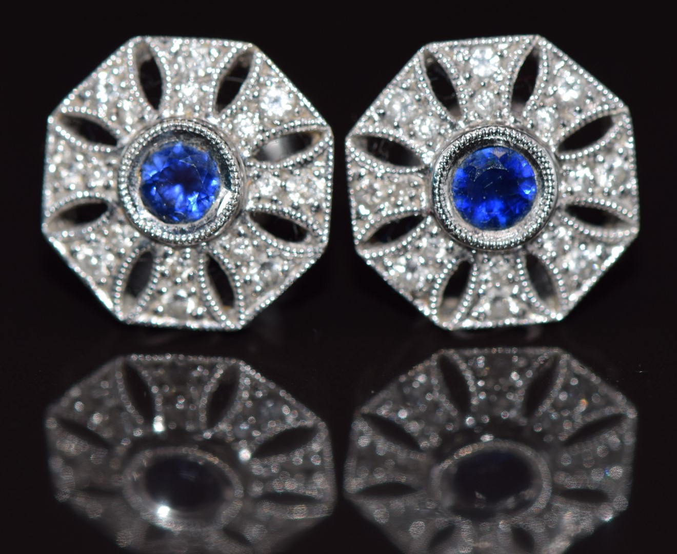 A pair of 18ct white gold earrings set with a sapphire and diamonds in a pierced setting, 4.1g 1.