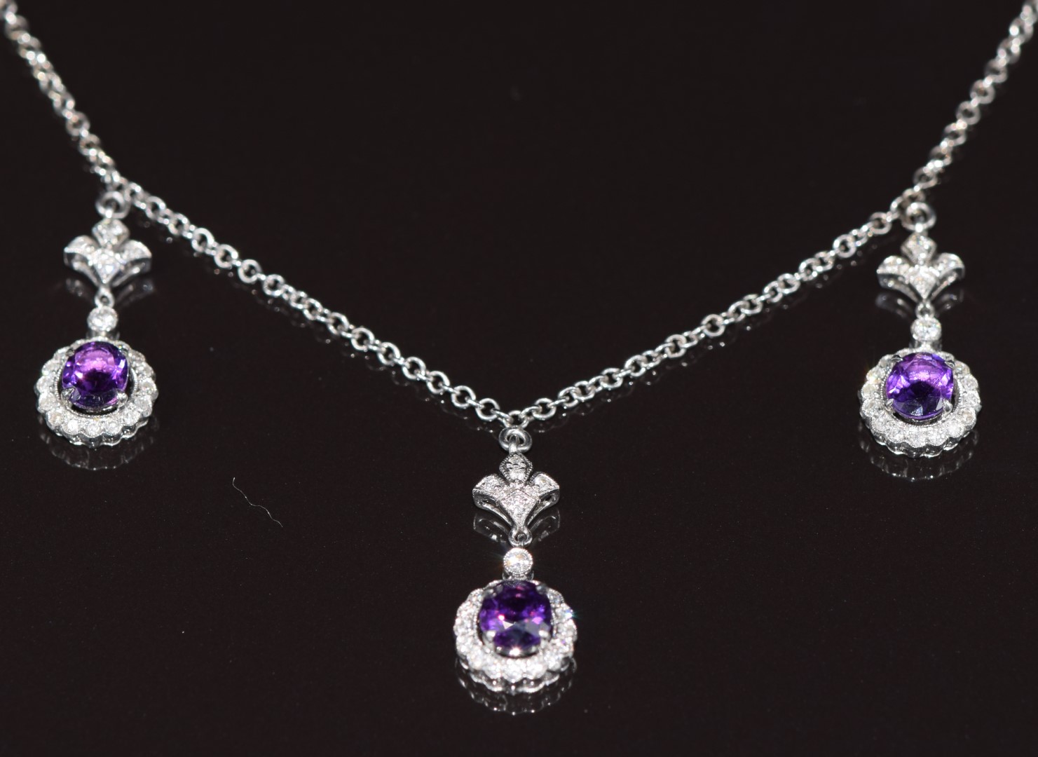 An 18ct white gold necklace with three drop sections set with oval cut amethysts and diamonds, 8.1g - Image 2 of 3