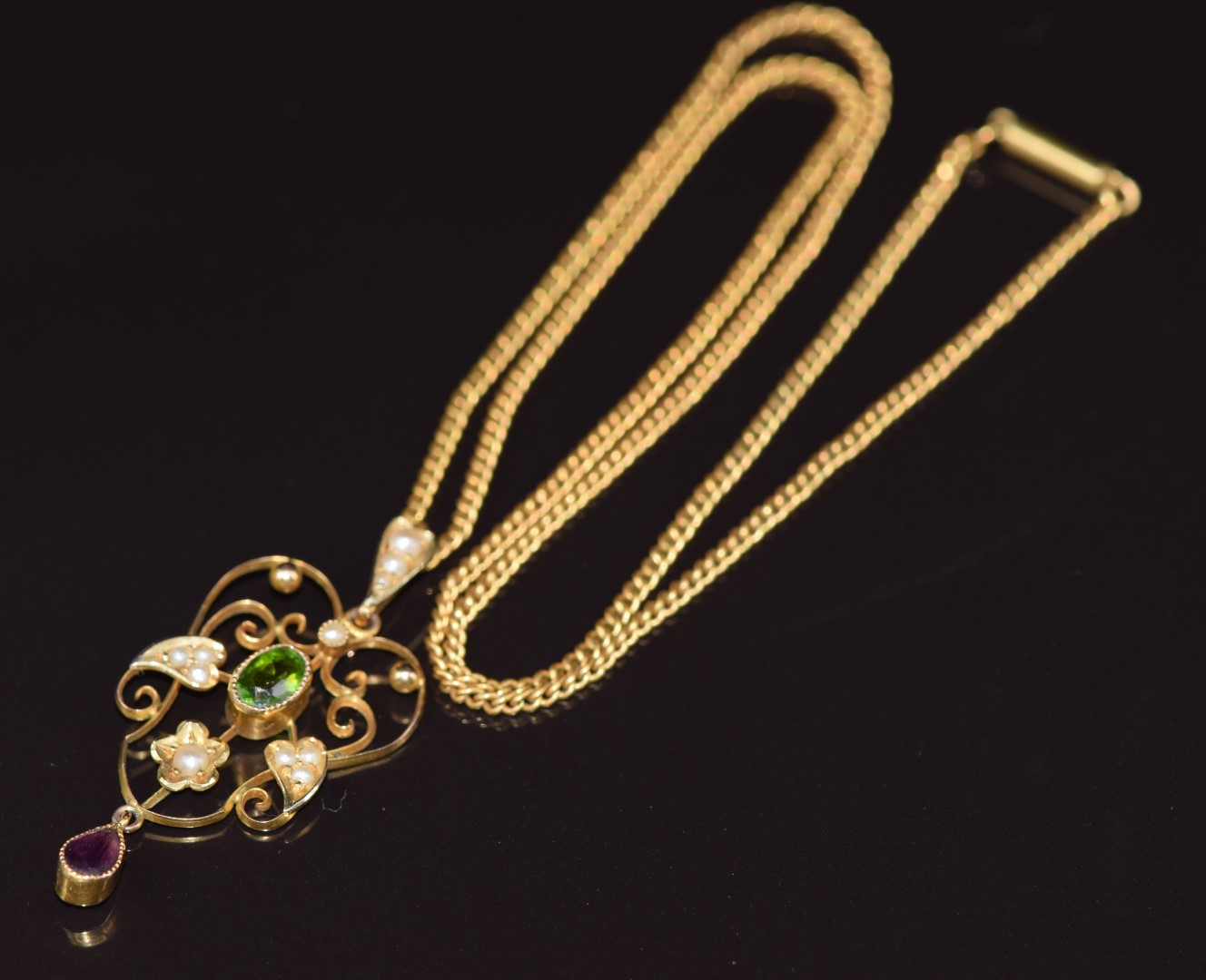 Edwardian 9ct gold Suffragette pendant set with peridot, amethyst and seed pearls, on a yellow metal