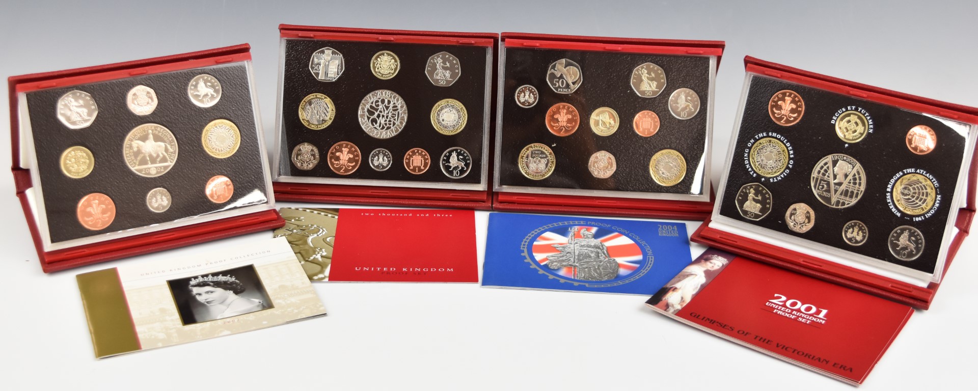 Four Royal Mint United Kingdom proof sets, from 2001 - 2004, all cased with certificates