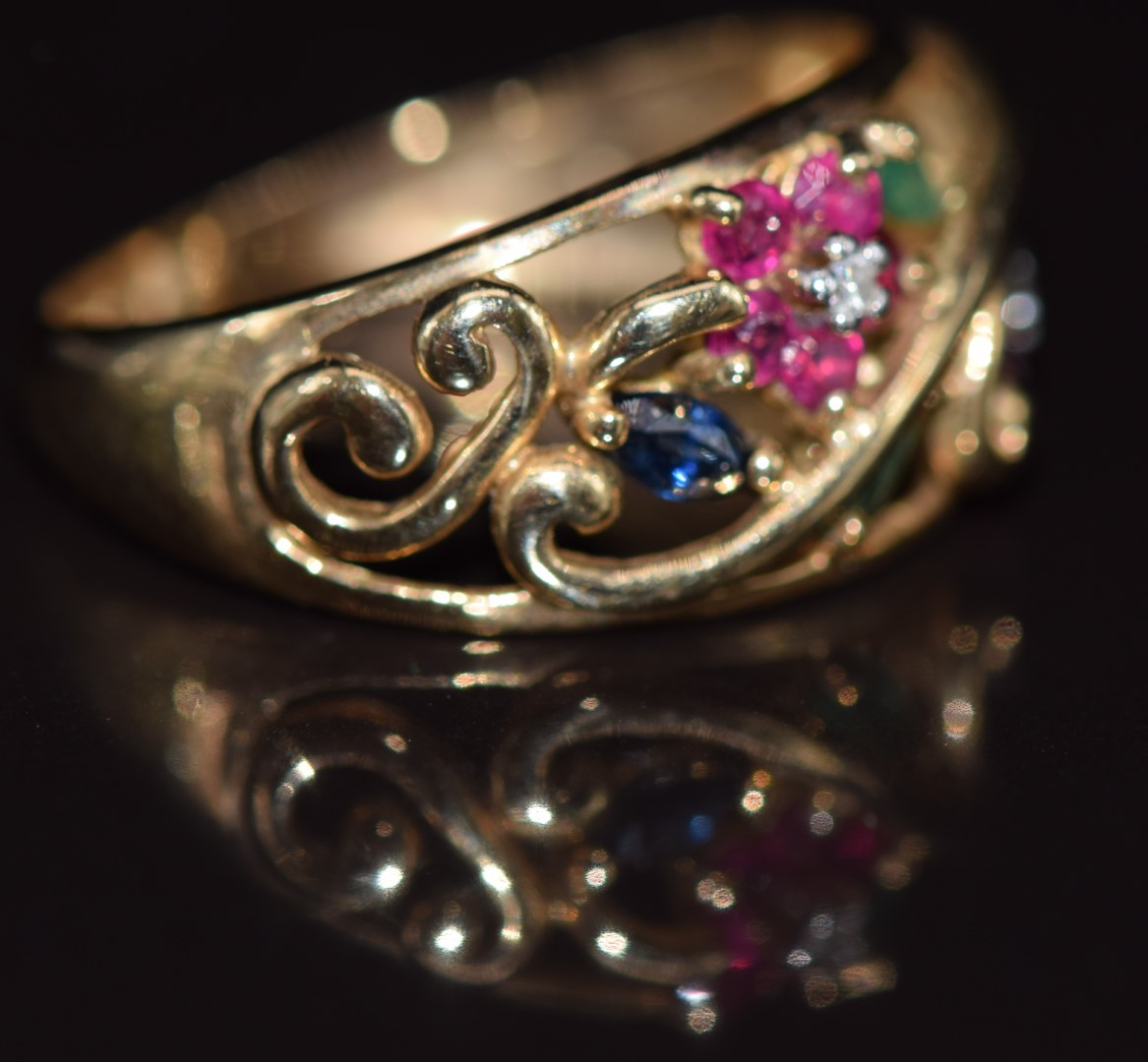 A 9ct gold ring set with diamonds, emeralds, sapphires and rubies in a floral pierced design, 2. - Image 2 of 2