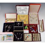 A collection of boxed costume jewellery including suites of paste set, enamelled, set of twelve