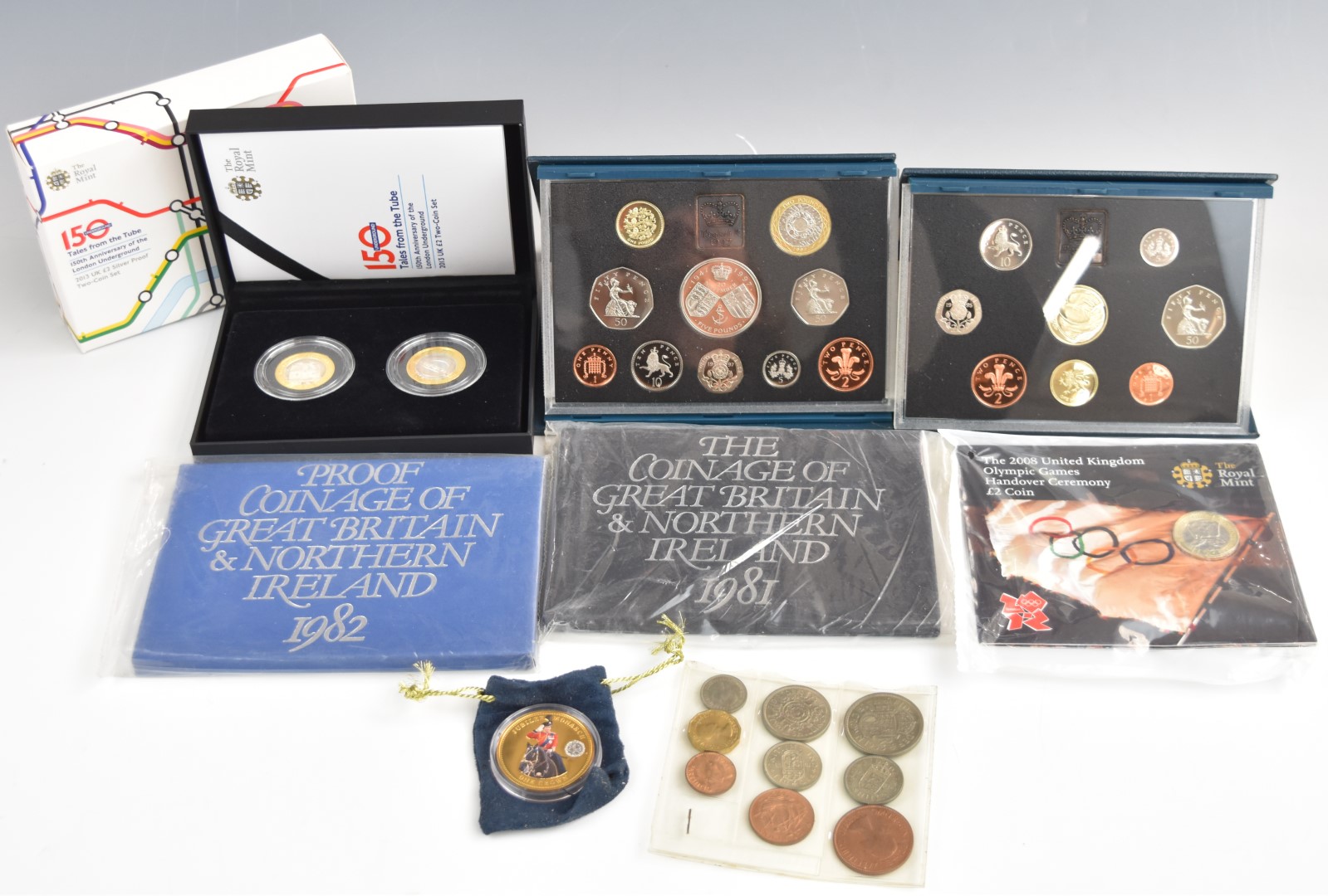 Four Royal Mint cased proof coin sets for 1981, 1982, 1995 and 1997, together with a cased 'Tales